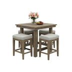 Dining set with a table and four stools in a room with large windows.