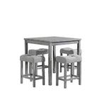 Gray dining table with four matching stools in a room with large windows and decorative elements.