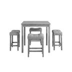 Gray dining set with table and chairs in a room with decor elements.