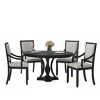 Dining room with a black round table and chairs in a modern interior setting.