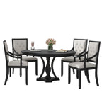 Dining room with a black round table and chairs in a modern interior setting.