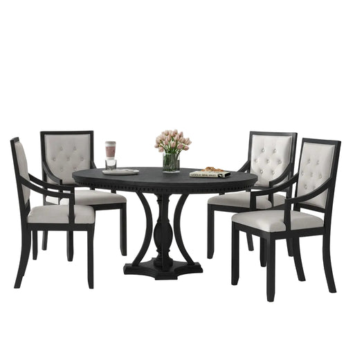 Dining room with a black round table and chairs in a modern interior setting.