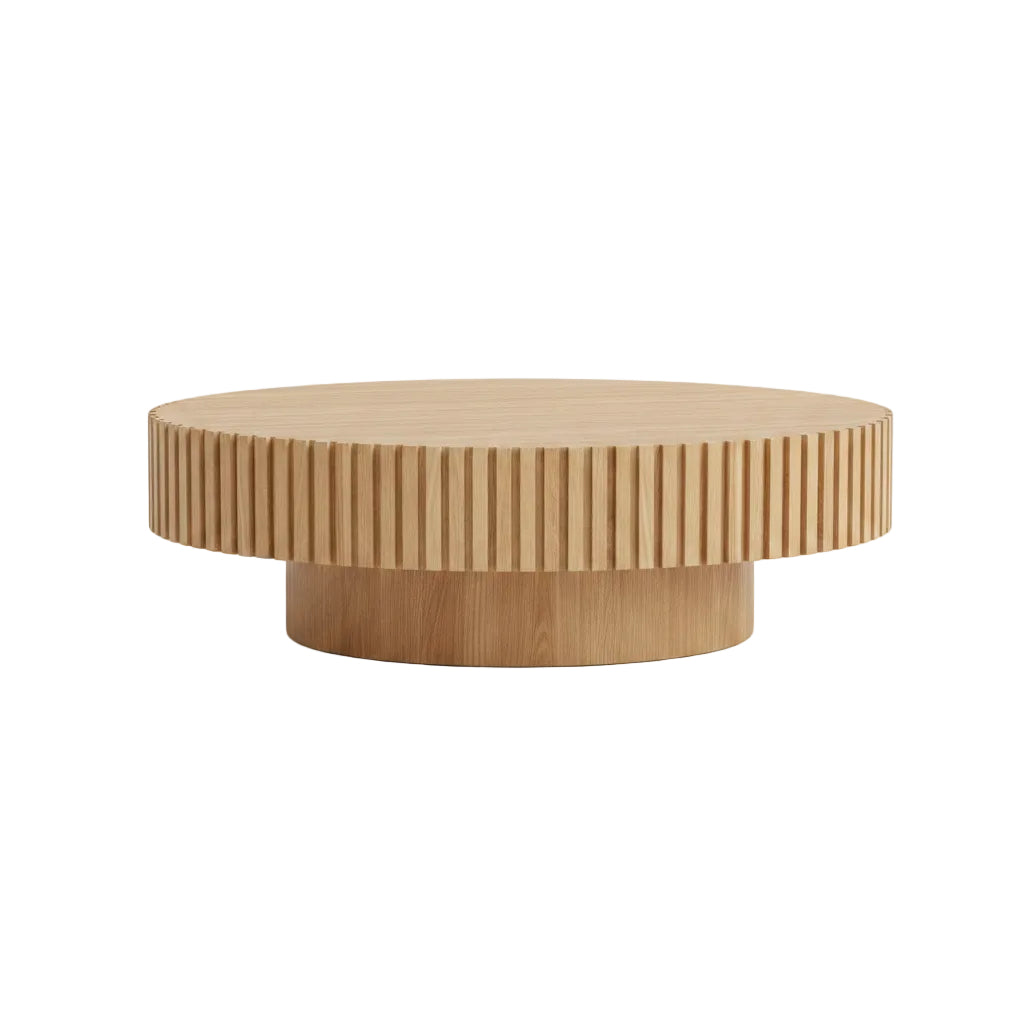 Round wooden coffee table in a living room setting with decor items.