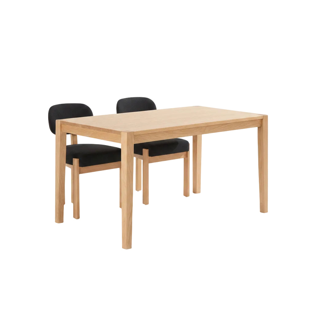 Dining table with two black cushioned chairs in a room with a white cabinet and decorative items.