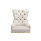 Beige tufted headboard with gold nailhead trim on a white background